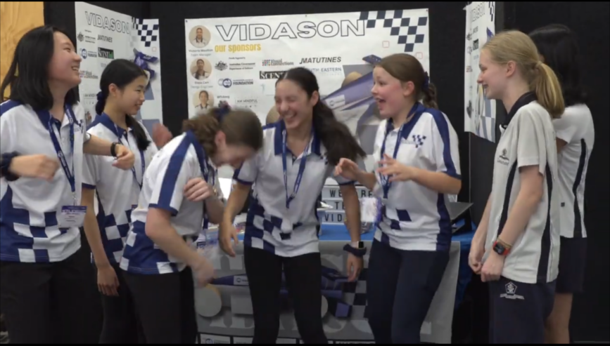A Team Of Students At F1 In Schools Victorian State Final, Having A Moment Of Laughter And Enjoyment Through The Day At Their Trade Booth